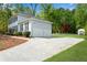 View of the garages, side yard and storage building behind the home at 1953 Windcrest Sw Dr, Lilburn, GA 30047
