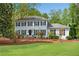 Charming two-story home with a well-manicured lawn and a classic facade with black shutters at 1953 Windcrest Sw Dr, Lilburn, GA 30047