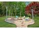 Fire pit area with Adirondack chairs, crushed gravel, and metal post string lights at 1953 Windcrest Sw Dr, Lilburn, GA 30047