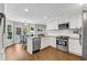 Bright, updated kitchen with stainless steel appliances, granite countertops and white cabinets at 1953 Windcrest Sw Dr, Lilburn, GA 30047