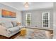 Cozy living room with large windows, a neutral color palette, and stylish decor at 1953 Windcrest Sw Dr, Lilburn, GA 30047
