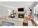 Inviting living room features built in shelving, a fireplace and lots of natural light from the large windows at 1953 Windcrest Sw Dr, Lilburn, GA 30047