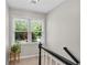 Stairwell window with a view to the back yard brings natural light to the staircase at 1953 Windcrest Sw Dr, Lilburn, GA 30047