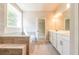 Modern bathroom featuring a double vanity, tub, and tiled flooring at 4082 Adler Cir, Buford, GA 30519