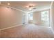 Spacious carpeted bedroom with a ceiling fan and windows providing natural light at 4082 Adler Cir, Buford, GA 30519