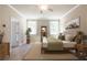 Staged bedroom featuring natural light, ceiling fan, with stylish decor elements at 4082 Adler Cir, Buford, GA 30519