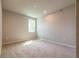 A cozy bedroom with neutral walls, plush carpet, and a bright window at 4082 Adler Cir, Buford, GA 30519
