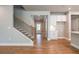 Bright foyer with stairs and adjacent storage, showcasing neutral tones and wood floors for a welcoming entrance at 4082 Adler Cir, Buford, GA 30519