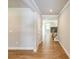 Hallway with wood floors leads to living spaces, showcasing neutral tones, and architectural details, enhancing the flow at 4082 Adler Cir, Buford, GA 30519