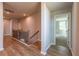 Bright hallway with wood floors, iron railing, and access to other rooms at 4082 Adler Cir, Buford, GA 30519