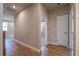 Light-filled hallway with hardwood floors and access to multiple rooms at 4082 Adler Cir, Buford, GA 30519