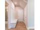 Hallway with bench seat, coat hooks, and hardwood floors, providing functionality and style at 4082 Adler Cir, Buford, GA 30519