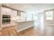 Spacious kitchen features stainless steel appliances, white cabinets, an island, and hardwood floors at 4082 Adler Cir, Buford, GA 30519