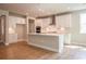 Kitchen with white cabinets, stainless steel appliances, a center island, and hardwood floors at 4082 Adler Cir, Buford, GA 30519
