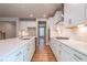Modern kitchen features white cabinets, quartz countertops, stainless steel appliances, and hardwood floors at 4082 Adler Cir, Buford, GA 30519