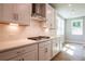 Close up of the kitchen featuring white cabinets, a stainless steel hood, and hardwood floors at 4082 Adler Cir, Buford, GA 30519