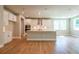 Bright kitchen with stainless steel appliances, white cabinets, large island, and hardwood floors at 4082 Adler Cir, Buford, GA 30519