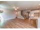 Open concept living room featuring hardwood floors, a fireplace and stairs leading up to the second story at 4082 Adler Cir, Buford, GA 30519