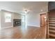 Bright living room features hardwood floors, a modern fireplace, ceiling fan and two windows at 4082 Adler Cir, Buford, GA 30519