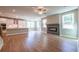 Bright open concept living room with a fireplace, hardwood floors and a kitchen with white cabinets at 4082 Adler Cir, Buford, GA 30519