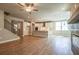 Open concept living room with hardwood floors, white kitchen with a center island, and a fireplace at 4082 Adler Cir, Buford, GA 30519