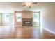 Bright living room features hardwood floors, a modern fireplace, ceiling fan and two windows at 4082 Adler Cir, Buford, GA 30519