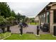Outdoor patio featuring a swing, seating, barbecue, water feature, and beautiful landscaping at 552 Warrenton Run Dr, Sugar Hill, GA 30518
