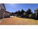 Spacious backyard features a wooden pergola, lush greenery, and ample space for outdoor enjoyment at 552 Warrenton Run Dr, Sugar Hill, GA 30518