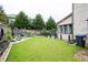 Beautiful backyard features a water feature, lush lawn, and mature trees, offering a private oasis at 552 Warrenton Run Dr, Sugar Hill, GA 30518