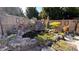 Backyard pond featuring a decorative rock waterfall, lush greenery, and a serene ambiance at 552 Warrenton Run Dr, Sugar Hill, GA 30518
