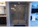 Well-lit bathroom features tile shower with glass doors, and double sink vanity at 552 Warrenton Run Dr, Sugar Hill, GA 30518