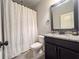 Bathroom showcasing granite countertops, black cabinetry, and modern fixtures at 552 Warrenton Run Dr, Sugar Hill, GA 30518