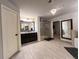 Bathroom offering a dual sink vanity, glass shower and ceramic tile flooring at 552 Warrenton Run Dr, Sugar Hill, GA 30518