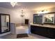 Bright bathroom features corner soaking tub, elegant light fixtures, and granite countertops at 552 Warrenton Run Dr, Sugar Hill, GA 30518
