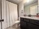 Bathroom featuring dark cabinetry, granite countertop, and shower with curtain at 552 Warrenton Run Dr, Sugar Hill, GA 30518