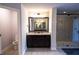 Bathroom boasts double sink vanity with granite counter, tile floor, and glass shower at 552 Warrenton Run Dr, Sugar Hill, GA 30518