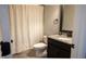 Bathroom features a vanity with granite countertop, shower with curtain, and a toilet at 552 Warrenton Run Dr, Sugar Hill, GA 30518