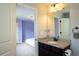 View into a lilac bedroom from the ensuite bathroom with dark cabinetry at 552 Warrenton Run Dr, Sugar Hill, GA 30518