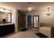 Modern bathroom features dual vanities, standalone tub, glass shower and tile floors at 552 Warrenton Run Dr, Sugar Hill, GA 30518