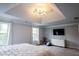 Bright bedroom with recessed lighting, decorative chandelier, and neutral color palette at 552 Warrenton Run Dr, Sugar Hill, GA 30518