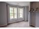 Bedroom with carpet, two double hung windows with curtains, and an open closet at 552 Warrenton Run Dr, Sugar Hill, GA 30518