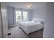 Bright bedroom boasts a large window and stylish decor at 552 Warrenton Run Dr, Sugar Hill, GA 30518