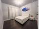 Minimalist bedroom featuring hardwood floors, neutral walls, and contemporary furnishings at 552 Warrenton Run Dr, Sugar Hill, GA 30518