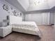 Elegant bedroom boasts a tray ceiling, decorative wall art, and a plush bed at 552 Warrenton Run Dr, Sugar Hill, GA 30518