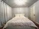 Cozy bedroom with a queen-sized bed, neutral decor, and ample natural light at 552 Warrenton Run Dr, Sugar Hill, GA 30518