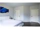 Bedroom featuring dark floors, a white bed, and two doors at 552 Warrenton Run Dr, Sugar Hill, GA 30518