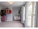 Spacious walk-in closet with custom shelving and large window for natural light at 552 Warrenton Run Dr, Sugar Hill, GA 30518