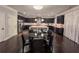 Open concept kitchen and dining area features hardwood floors, stainless appliances and granite countertops at 552 Warrenton Run Dr, Sugar Hill, GA 30518
