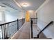 Upstairs hallway with decorative lighting, carpet floor, and dark wooden handrail at 552 Warrenton Run Dr, Sugar Hill, GA 30518