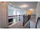 Upstairs hallway featuring carpet, decorative lighting, and dark wood handrail at 552 Warrenton Run Dr, Sugar Hill, GA 30518